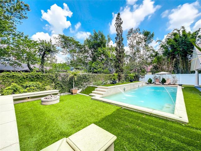 Pool w/view of rear of home and garage to the left