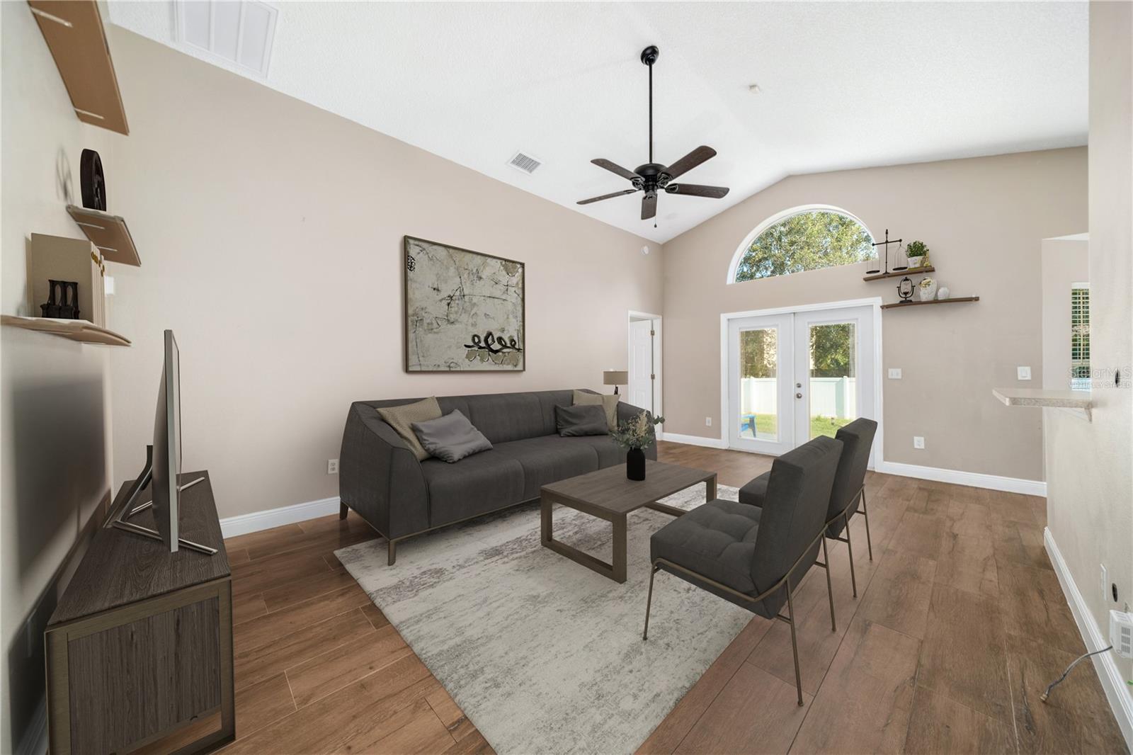Virtually staged - the great room gets wonderful light from the large windows opening into the backyard