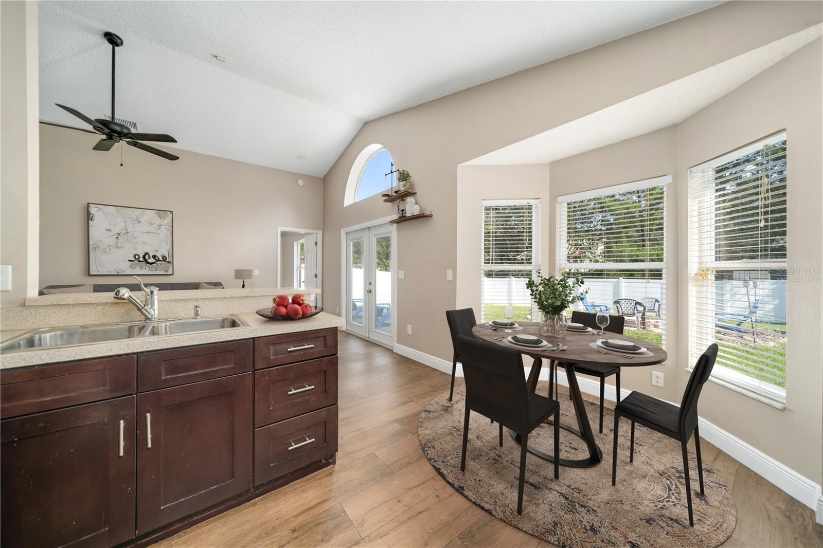 Virtually staged - beautiful bay window looking into backyard is perfect for the dining table