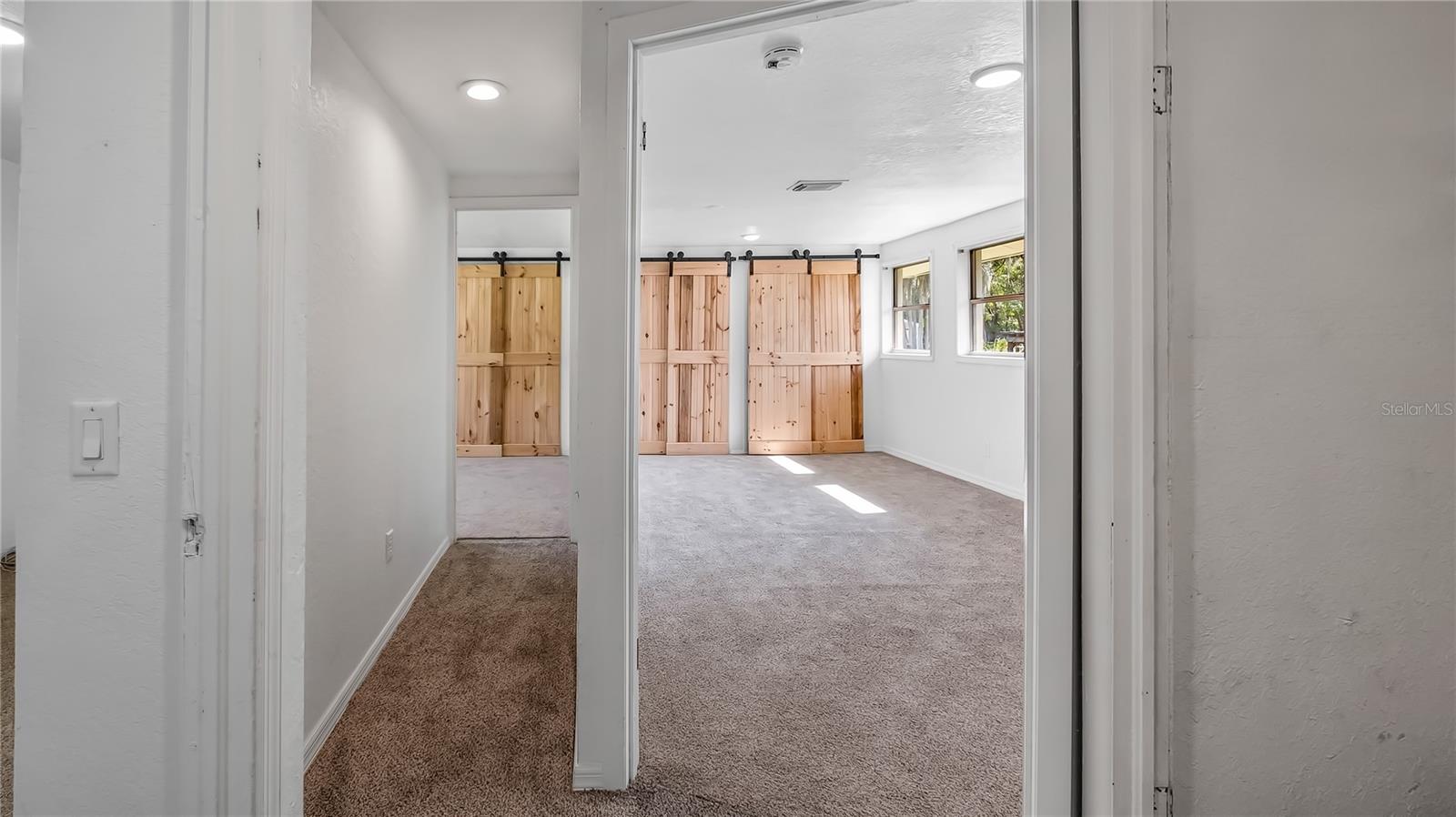 From living room hall way looking down to what could be a master on the right and both secondary rooms on the left.  Second bathroom is on right