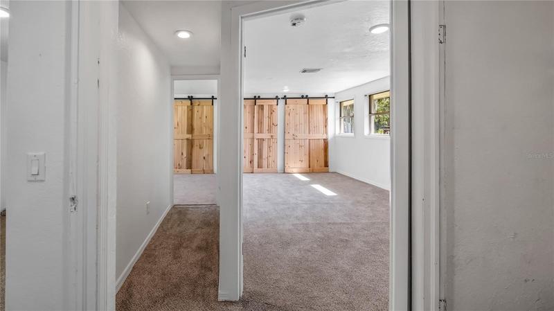 From living room hall way looking down to what could be a master on the right and both secondary rooms on the left.  Second bathroom is on right