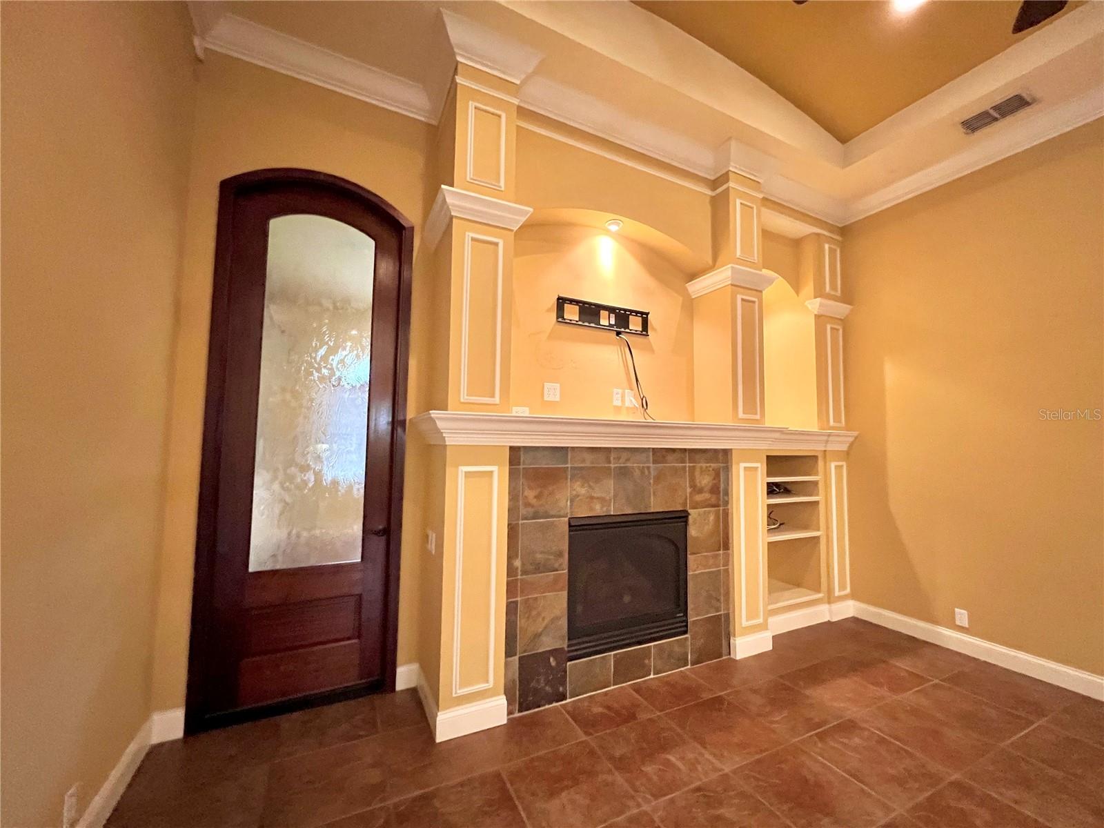 family room w/ beautiful &amp; very unique wooden door leading to game room