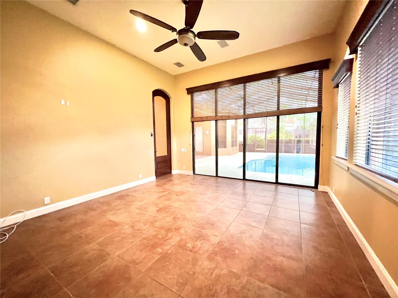 game room overlooking pool w/ double sliders