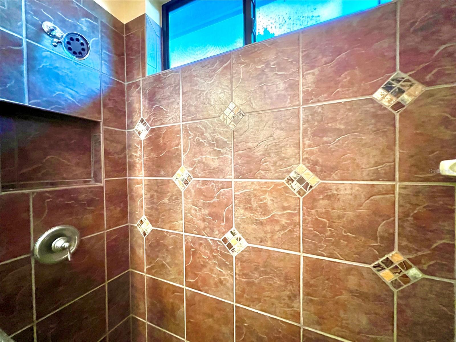 3rd bathroom has nicely tiled shower