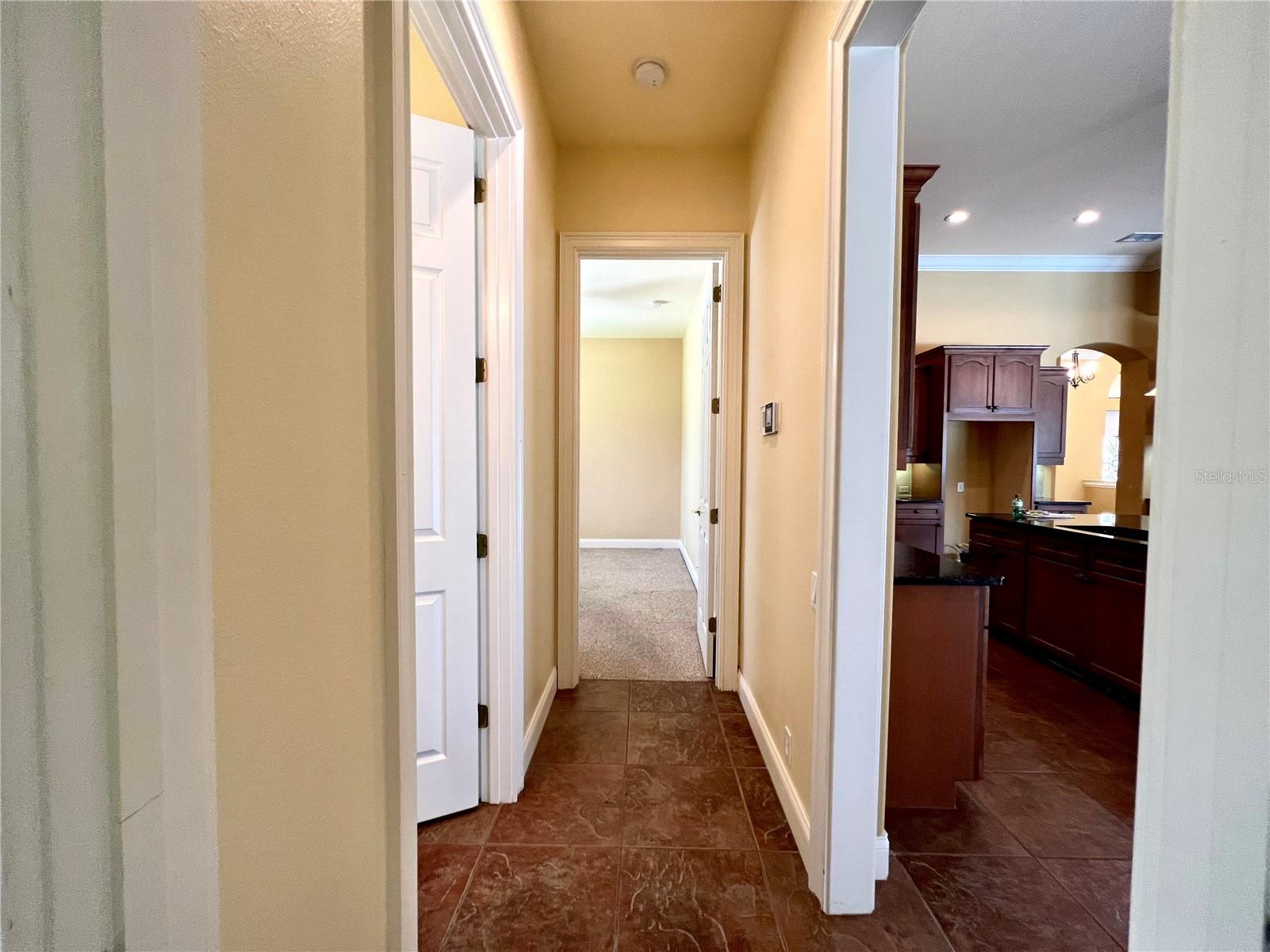 Hallway from 2nd BR to 3rd BR w/ hall bathroom entrance