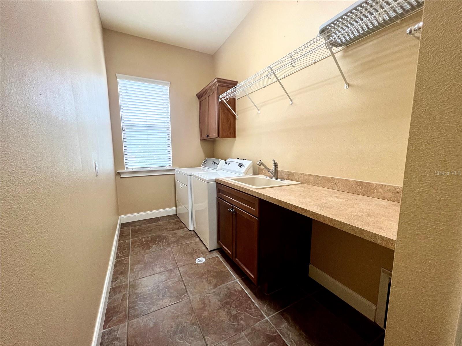 Nice size laundry rm w/ folding countertop, washtub &amp; floor drain