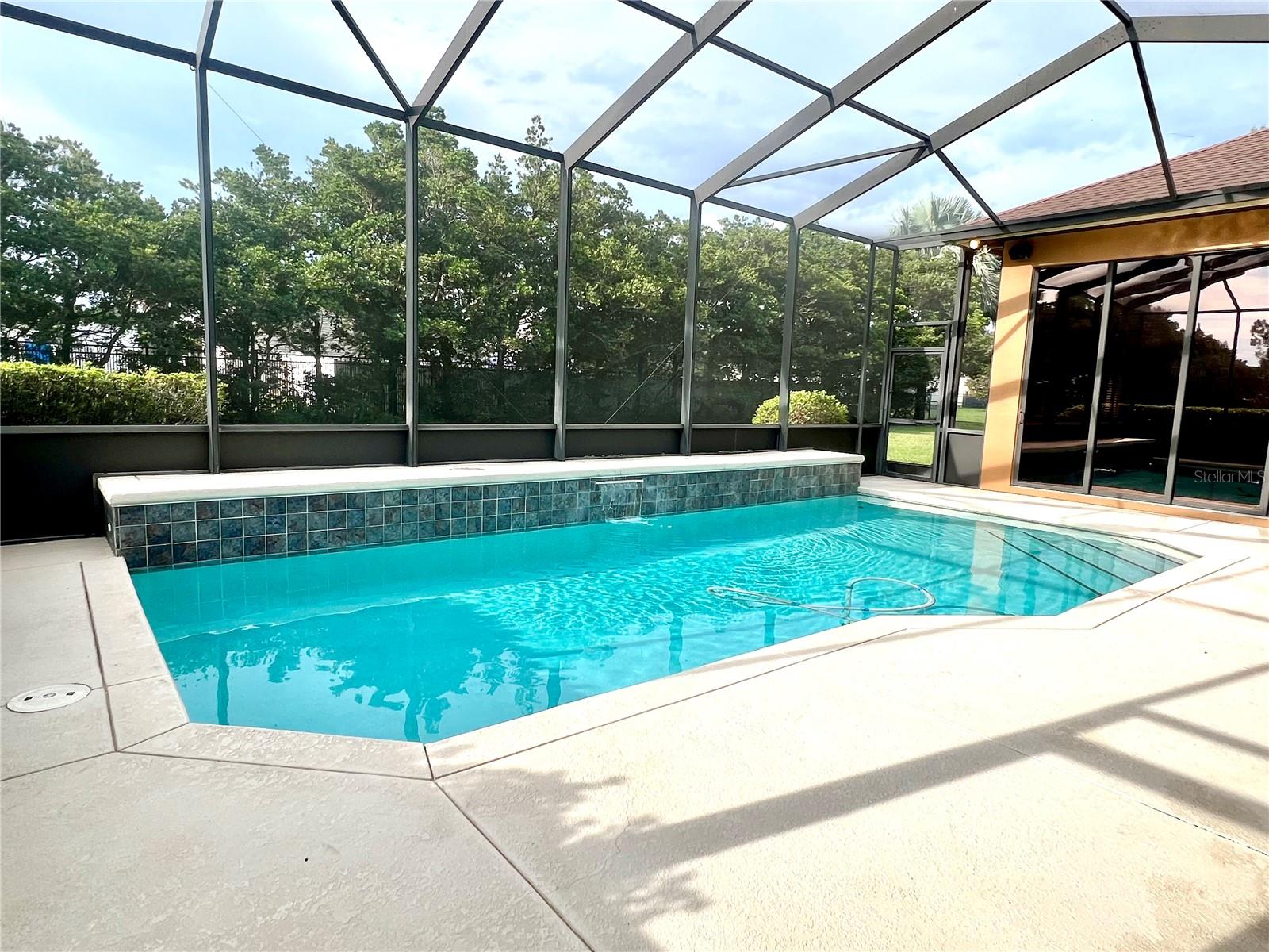 Lovely screened pool w/ waterfall feature