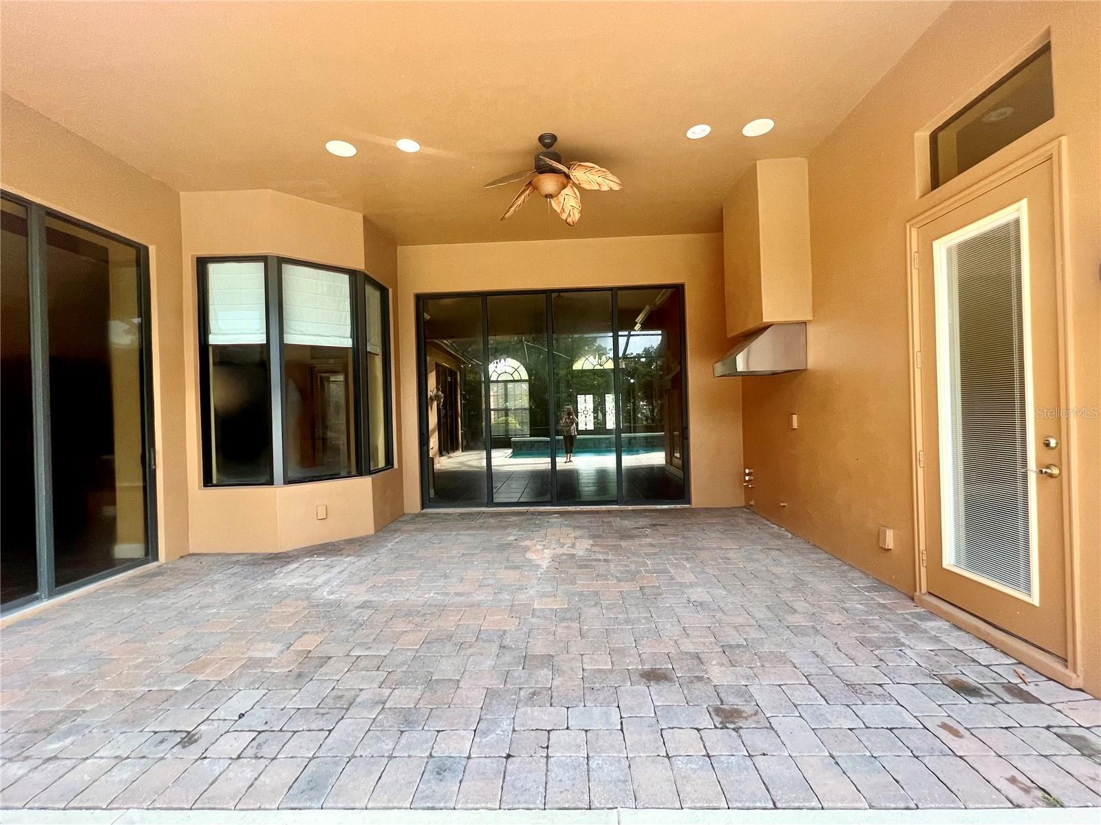 Enclosed &amp; covered patio w/ pavers &amp; grill vent