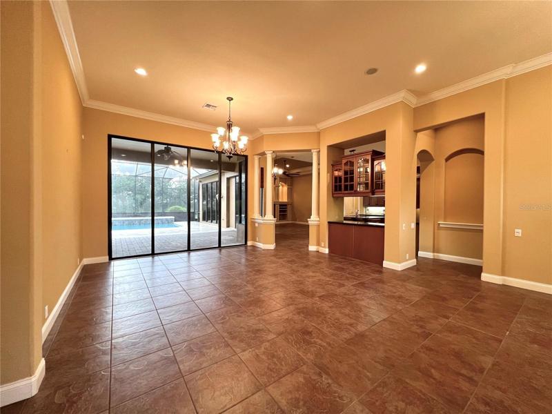 Living room w/ sliders leading to pool area