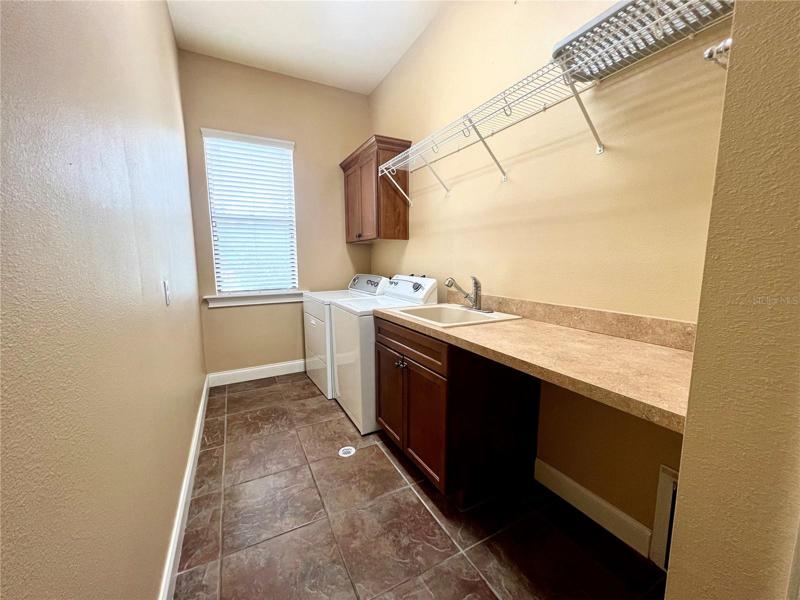 Nice size laundry rm w/ folding countertop, washtub & floor drain