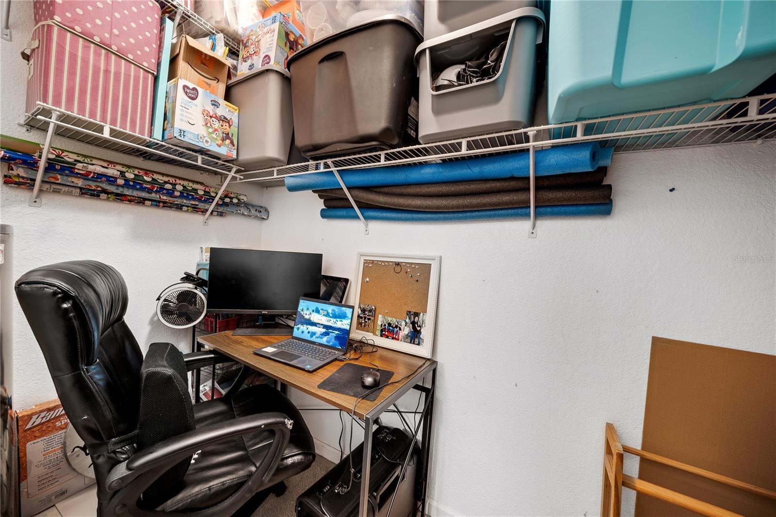Closet being used as small office.