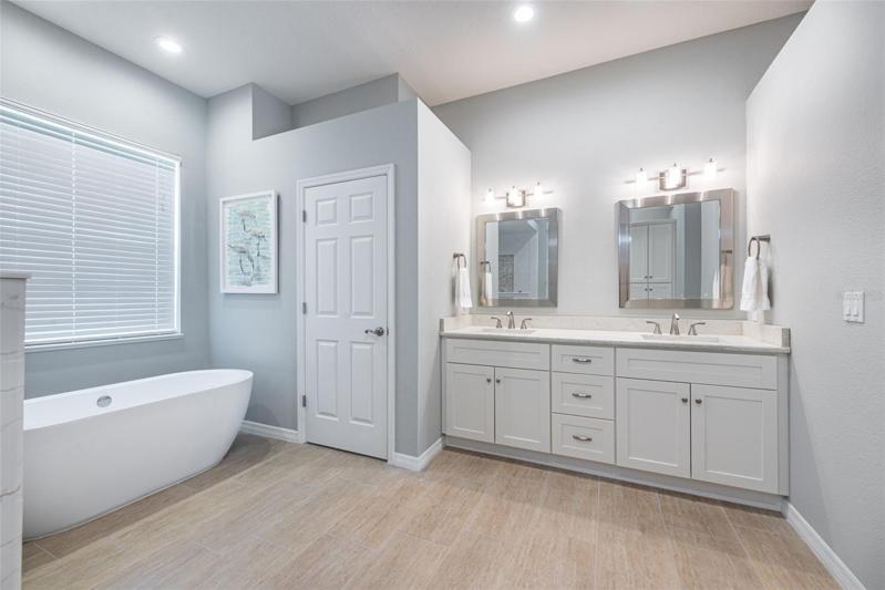 Master bath with dual sinks and lots of storage and a modern soaking tub.