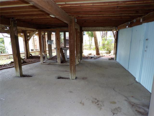AREA BELOW AT BASE OF HOME IN REAR.