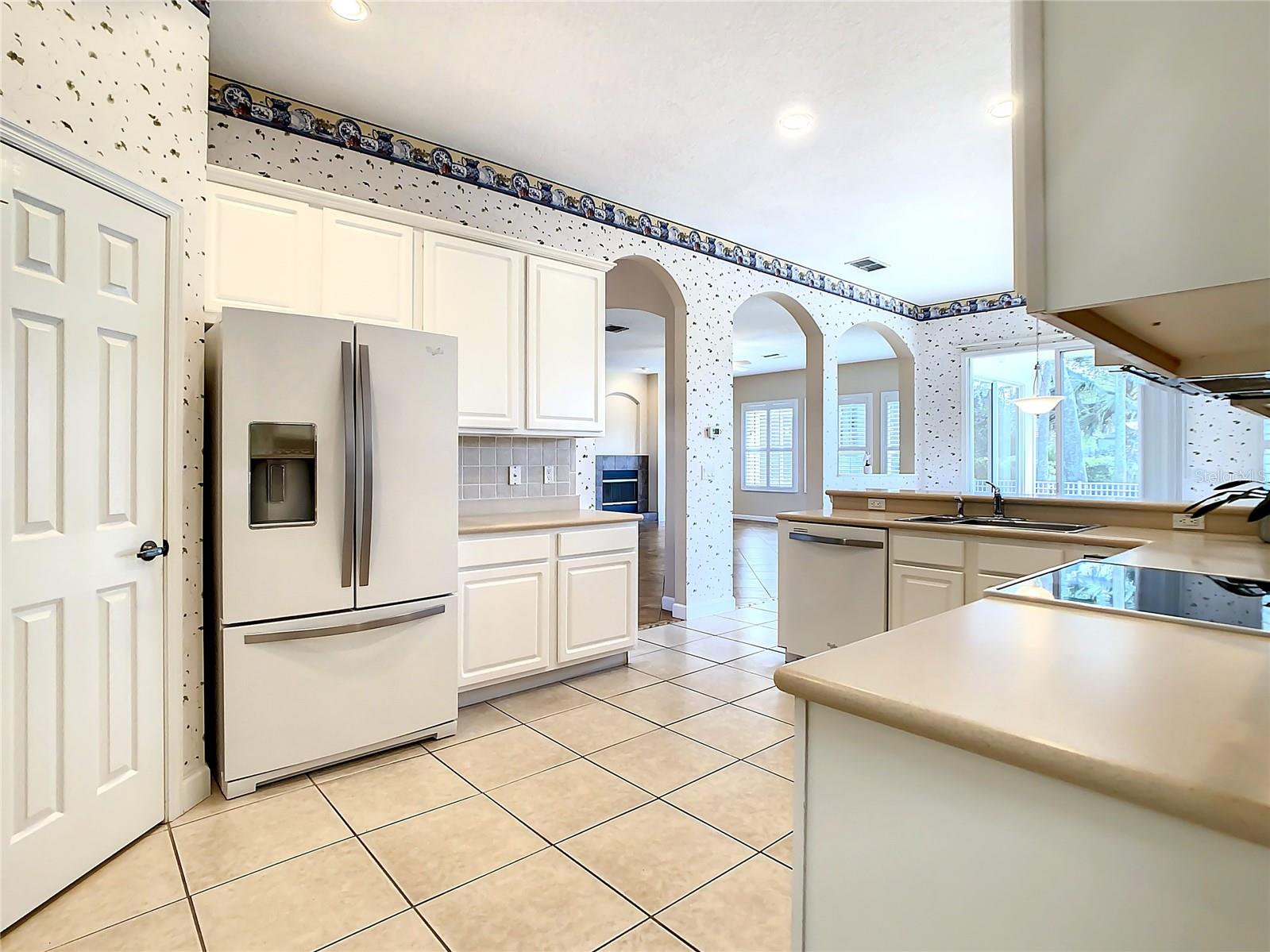 View into kitchen from garage entry and laundry room entrance