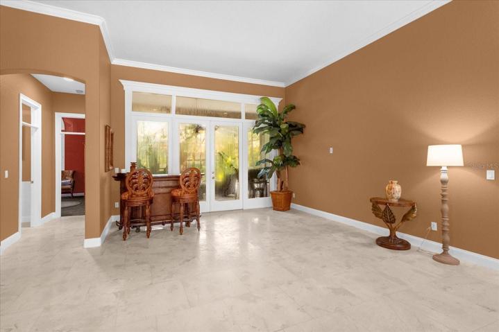 Living room with hall to half bath and owner's suite