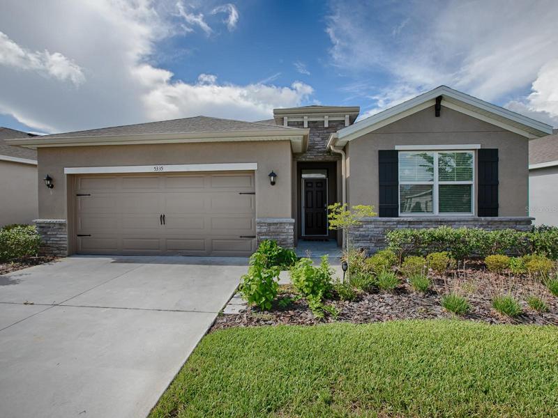 LOVELY LANDSCAPING AND CURB APPEAL ON THIS DELRAY MODEL