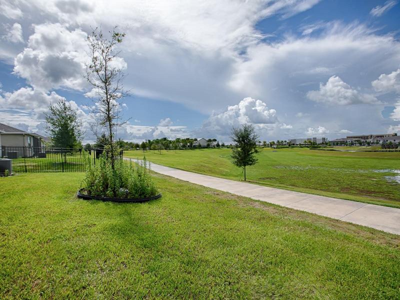 LOTS OF GREENERY AND A WALKING PATH BEHIND THIS HOME