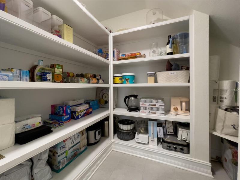PANTRY WITH WOOD SHELVES AND EXPANSIVE STORAGE