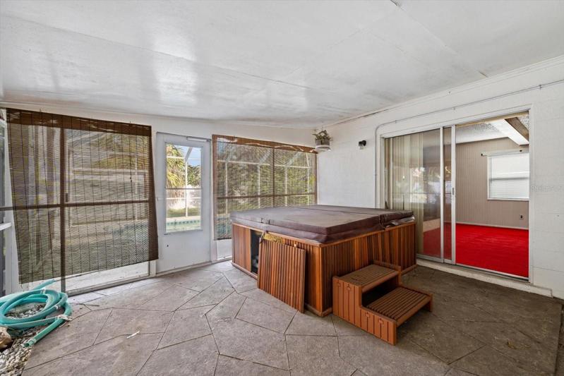 Enclosed, screened in area by pool (hot tub does not convey)