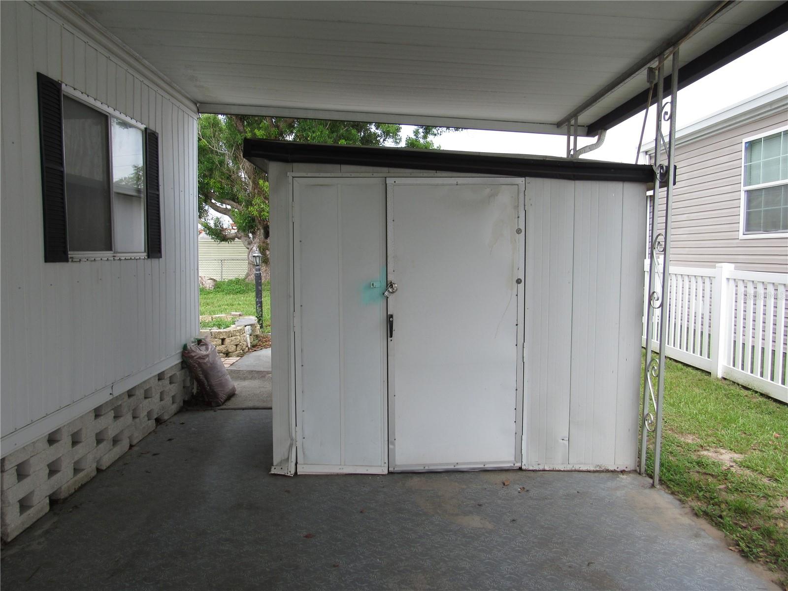 Utility shed with storage &amp; washer/dryer.