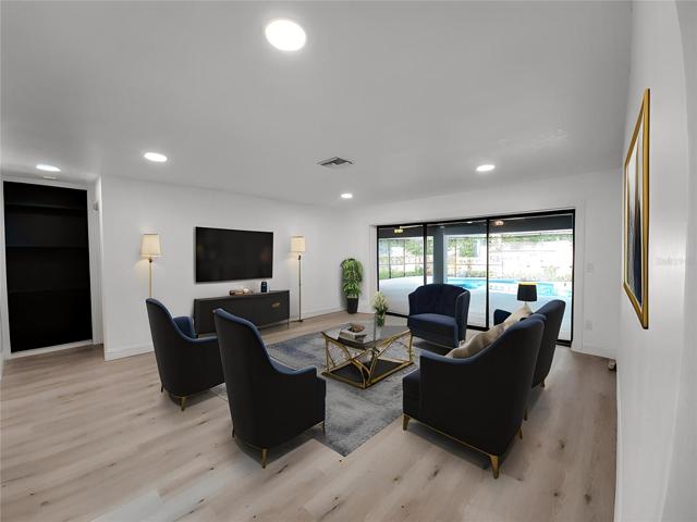Your Double Door Entry opens to a Living Room with Triple Sliders that pocket away for Lanai Access