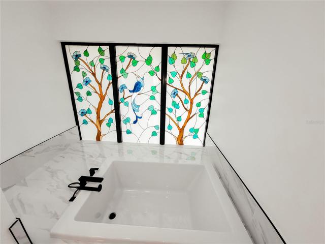 Large Soaking Tub with mounter waterfall tub filler.