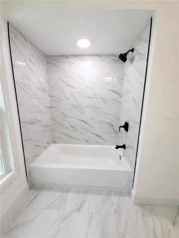 with porcelain tile, new fixtures and lighting