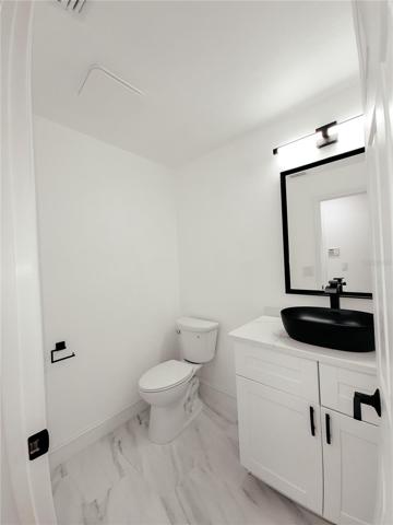 Half Bath again totally updated with new toliet, cabinet and another wonderful Matt Black Vessel Sink!