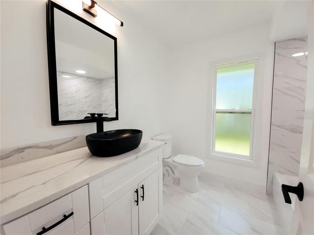 Full Bath has been updated and upgraded with Vanity with Matt Oval Vessel Sink top mounted, black hardware and beautifully done shower