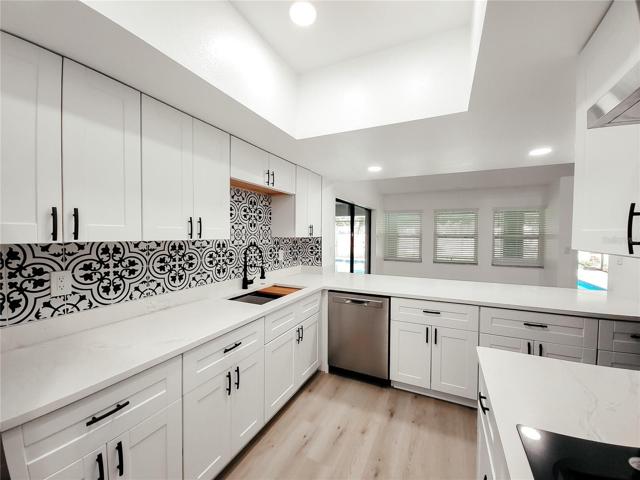 Recessed lighting and Shaker Style Cabinets in white with soft close doors