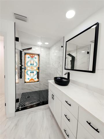 Black hardware and accents throughout, water closet