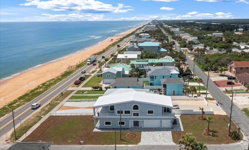 Front elevation of this custom home on the corner of A1A (Ocean Shore Blvd) and S 23rd Street