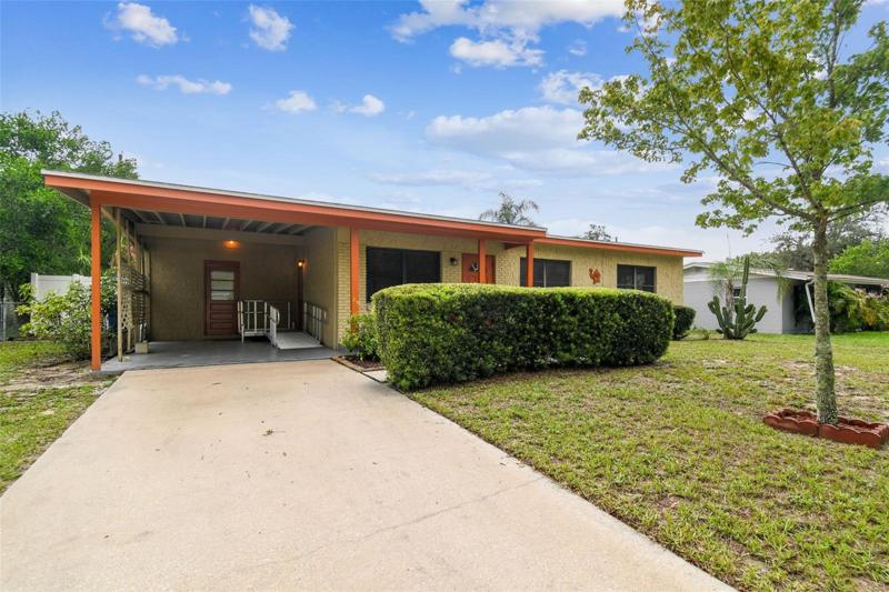 Elongated Driveway Leading to 1Carport with Easy Side Entrance and Back Outdoor Laundry Room!