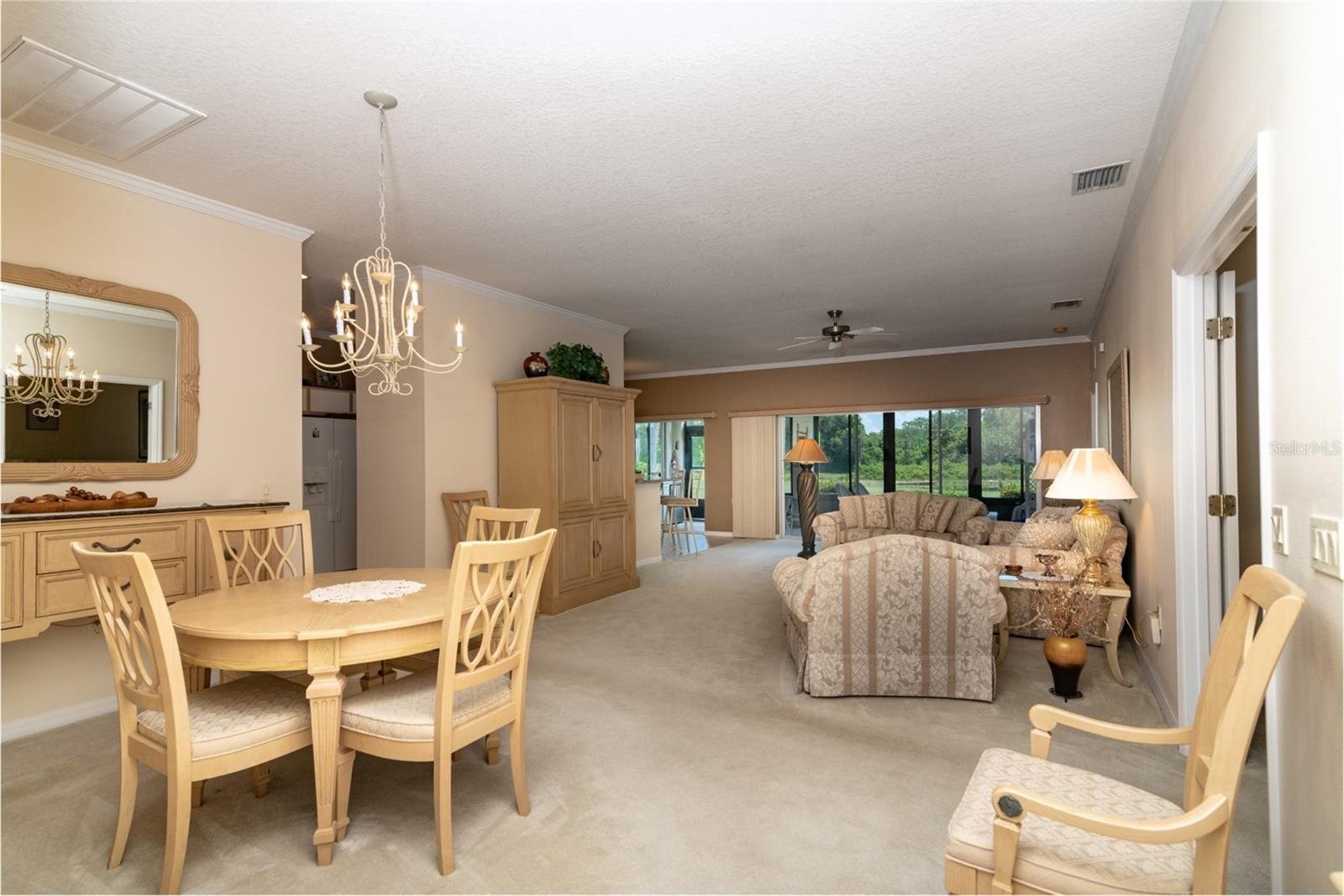 This is the view from the foyer that shows the combination living and dining room, the central core of this beautiful home.