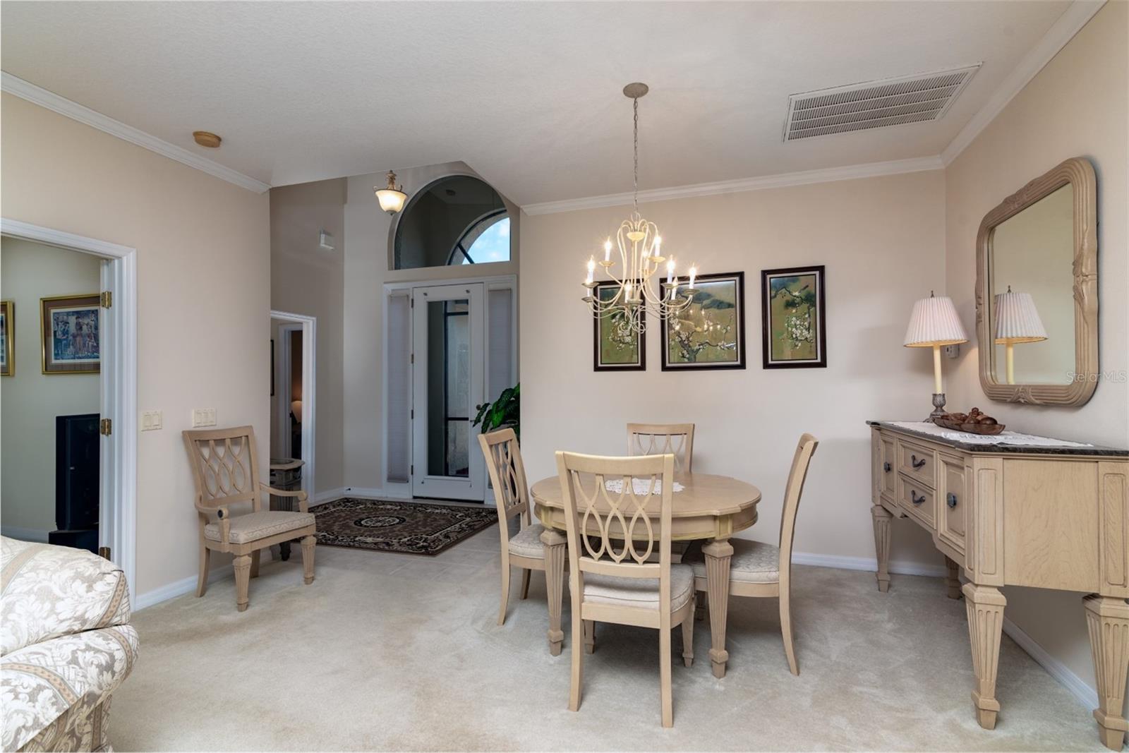 The doorway to the guest suite is in the vaulted foyer. The doorway to the den is on the right.