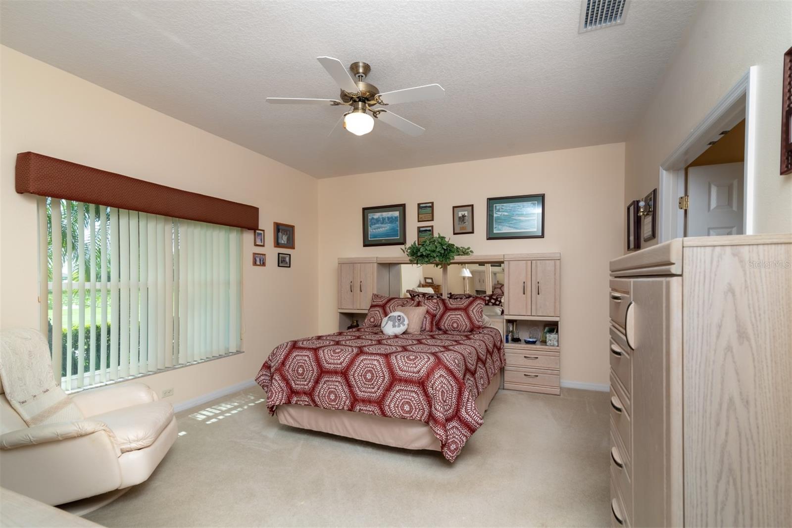The master bedroom has quality carpeting and ceiling fan with light.