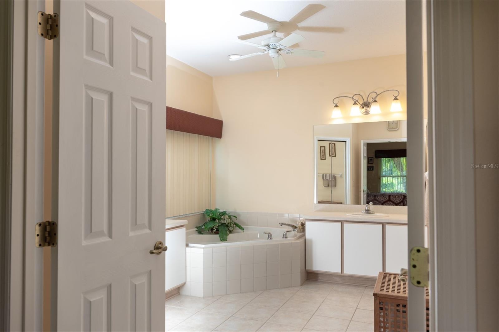 The double door can be closed when an early riser and late sleeper share the master suite.