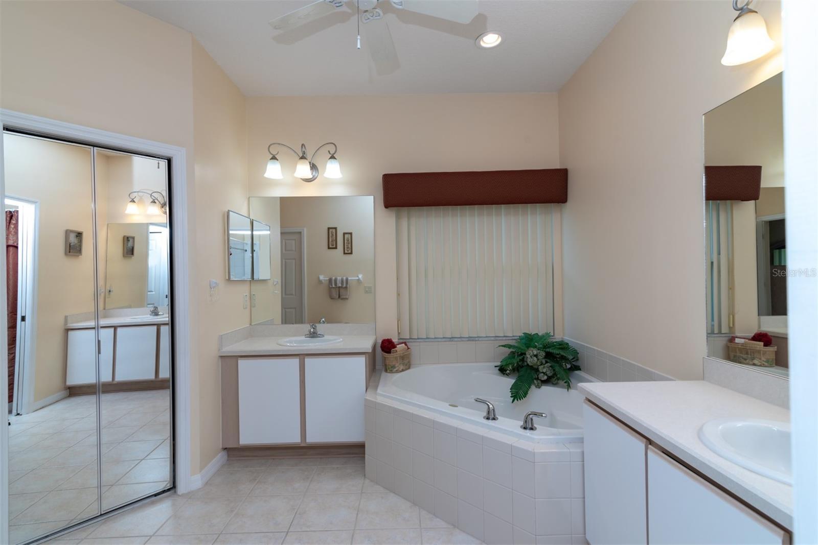 The master bath has 2 separate vanities and a corner garden tub.