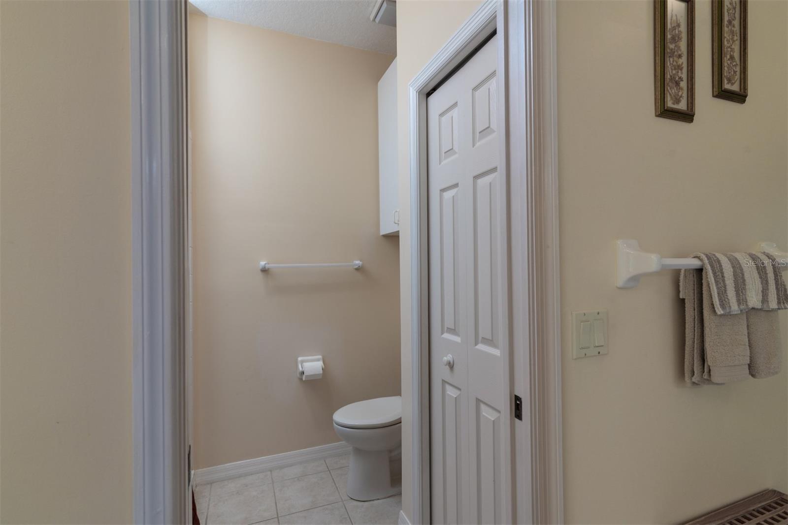 The toilet and stall shower area is home to the linen closet. A pocket door can close off this area.