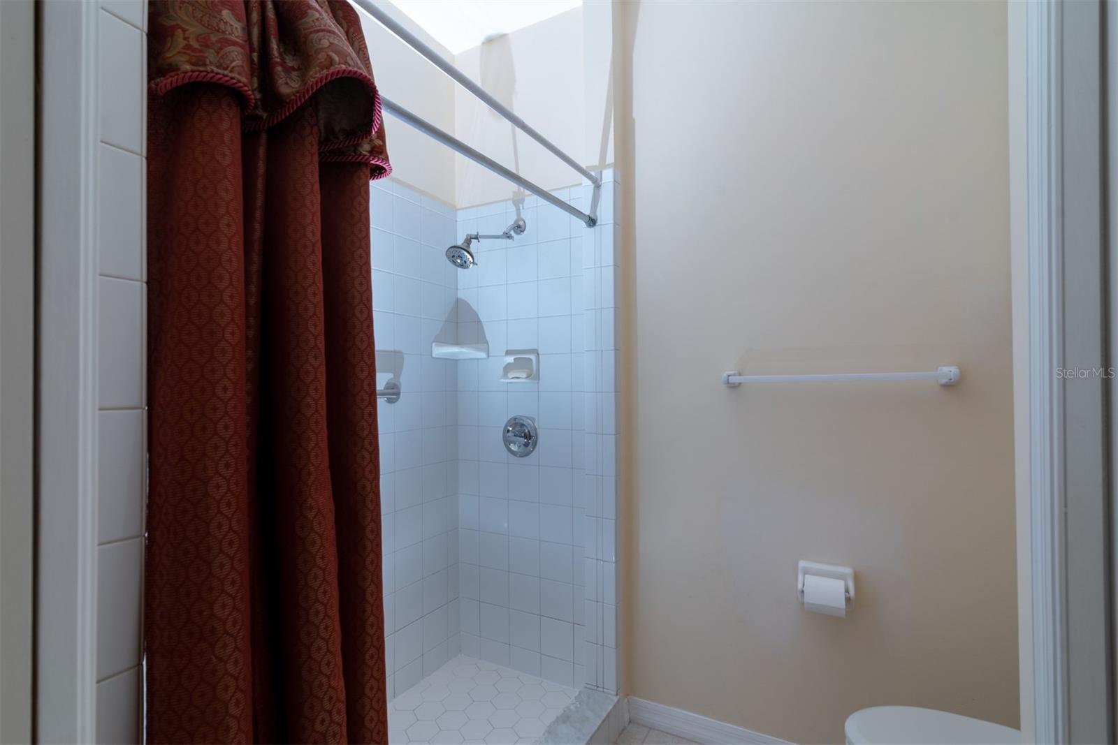 The elongated stool and stall shower fill this privacy area of the master bathroom.