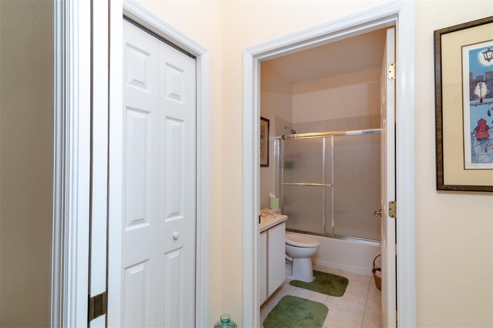 The guest suite linen closet is in the hallway between the guest bath and bedroom.