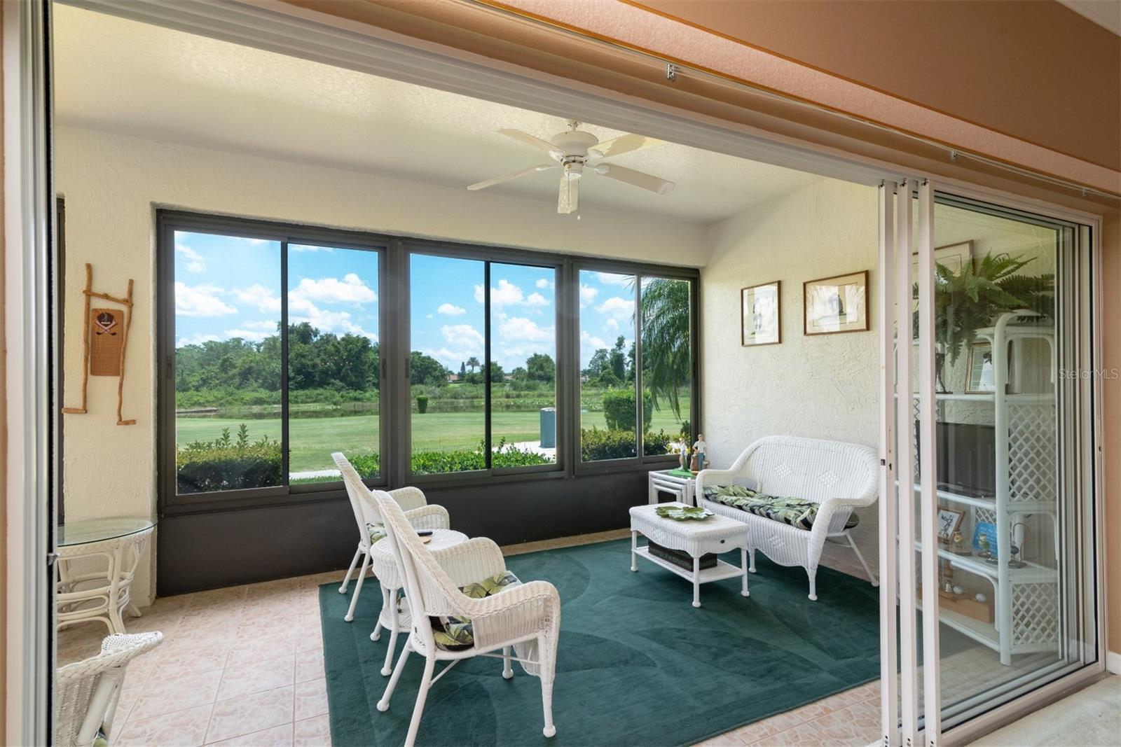 The triple slider in the living room opens to the covered and enclosed lanai.