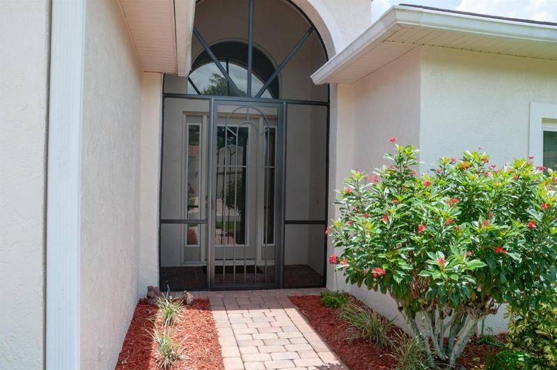 The screened entry makes cross ventilation a breeze. The full-length glass front door, sidelights and over the transom arched window provide great natural light to the foyer.