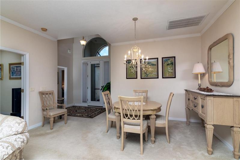 The doorway to the guest suite is in the vaulted foyer. The doorway to the den is on the right.
