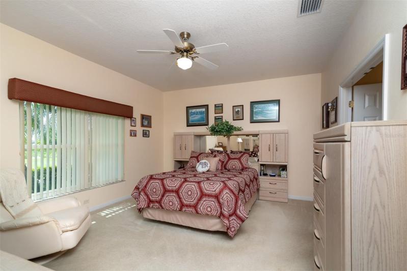 The master bedroom has quality carpeting and ceiling fan with light.