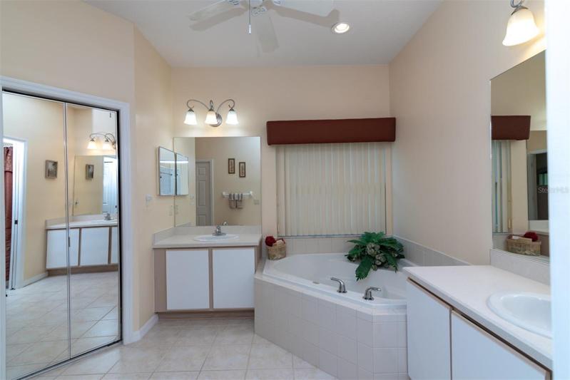 The master bath has 2 separate vanities and a corner garden tub.