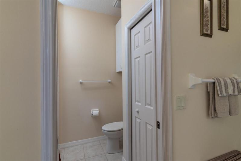 The toilet and stall shower area is home to the linen closet. A pocket door can close off this area.
