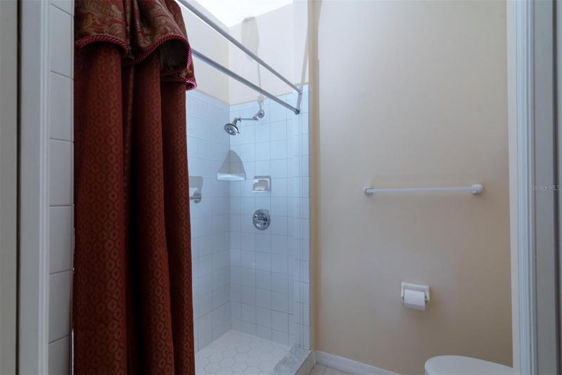 The elongated stool and stall shower fill this privacy area of the master bathroom.