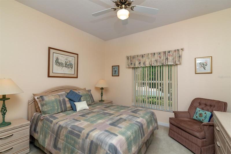 The guest bedroom is at the front of the home and has a ceiling fan with light.