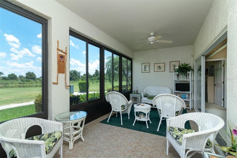 The 10x24 enclosed lanai has ceramic tile flooring and ceiling fans.
